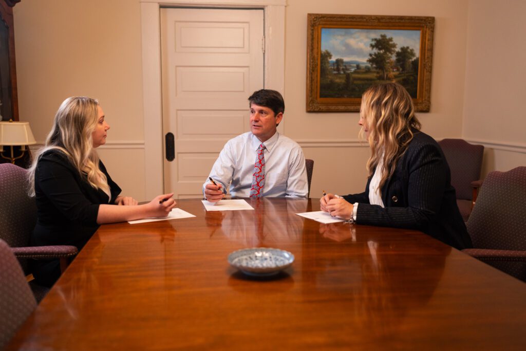 attorney met lane and team discussing case in conference room